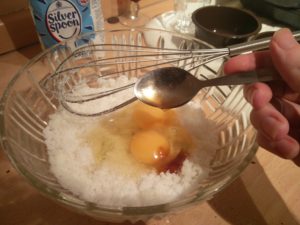 The vanilla extract being poured into the mix