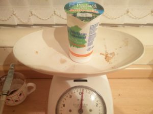 Weighing a carton of buttermilk to see how much was needed