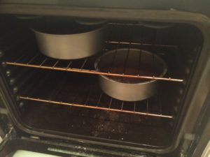 The cake pans in the oven, after being baked