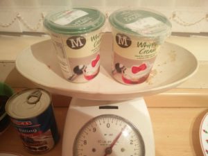 The cartons of whipping cream on the scales