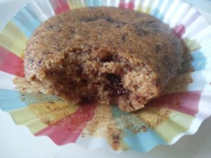 A cupcake with a bite taken out of it, showing the gooey chocolate