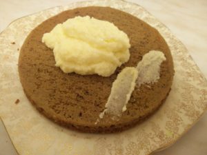 The icing filling dolloped on the bottom cake half