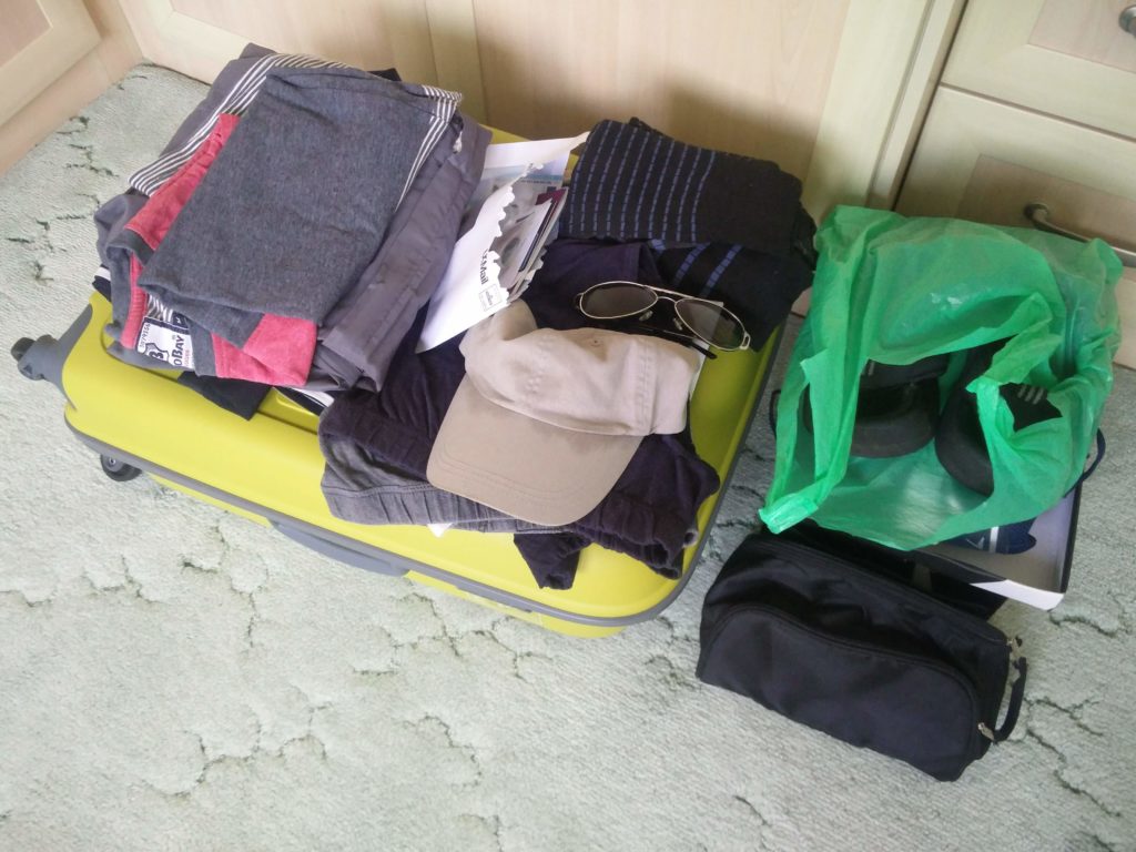 A selection of clothing on top of my suitcase